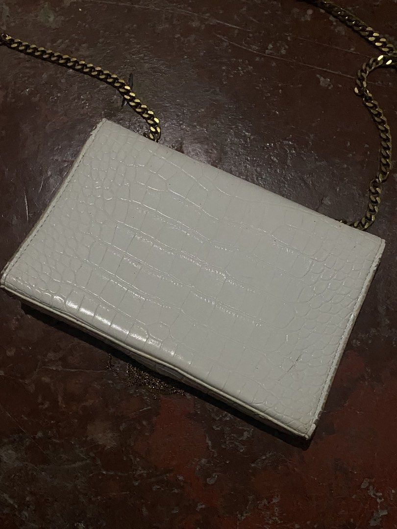 Saint Laurent White Croc Embossed Chain Wallet Bag (Category: Luxury Bags & Wallets) located in Davao. Submitted by singkorayk15407 (Listing ID 1471237111, Image 2). Description: - Authentic Saint Laurent crossbody bag - Premium white croc-embossed leather with gold hardware - Iconic YSL logo and stylish tassel detail - Convenient chain strap for easy wear - Secure magnetic snap closure - Interior features YSL Paris heat stamp and built-in card s