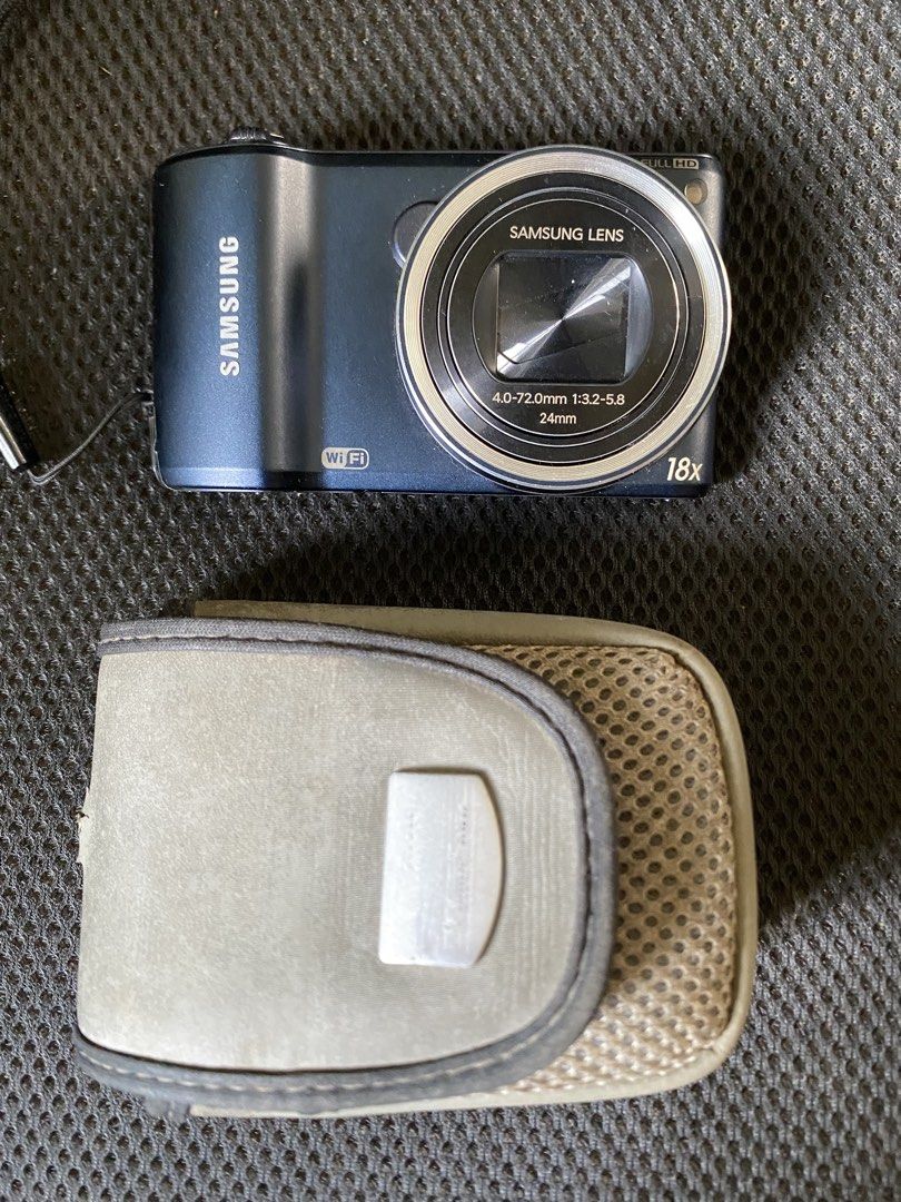 Samsung® WB250F Compact Digital Camera with Case (Category: Cameras) located in Cainta. Submitted by stuff_4_sale_dump (Listing ID 1471197913, Image 2). Description: midnight blue color 18x optical zoom and 24mm wide angle full HD video recording capability built-in Wi-Fi untested, clean body, and scratch-free lens includes original battery and grey protective carry pouch (Canon) issue: battery door doesn’t lock in place, have to had it taped (se