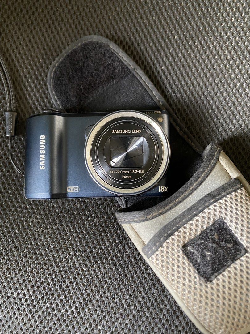 Samsung® WB250F Compact Digital Camera with Case (Category: Cameras) located in Cainta. Submitted by stuff_4_sale_dump (Listing ID 1471197913, Image 1). Description: midnight blue color 18x optical zoom and 24mm wide angle full HD video recording capability built-in Wi-Fi untested, clean body, and scratch-free lens includes original battery and grey protective carry pouch (Canon) issue: battery door doesn’t lock in place, have to had it taped (se