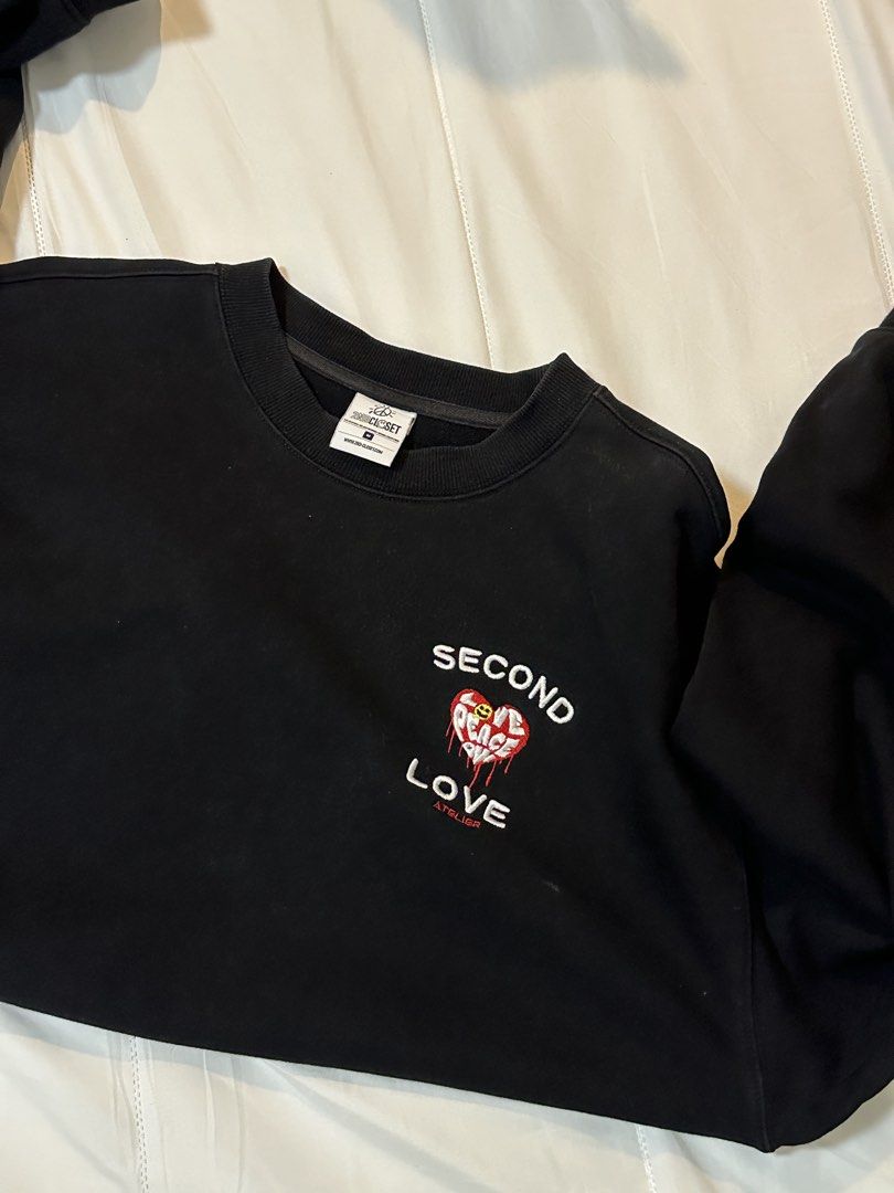 Second Love Peace & Love Sweatshirt (Category: Longsleeves) located in Bulacan. Submitted by juyeonloey (Listing ID 1471262916, Image 1). Description: - Brand: 2nd Closet Atelier - Color: Black - Size: M (tag on collar) - Front details: Embroidered 'SECOND LOVE' text with red heart and smiley face - Back details: White cursive 'Peace & Love' lettering - Pit to pit: ~24.5 inches - Length: ~28.5 inches - Features ribbed cuffs and hem, clean piece w