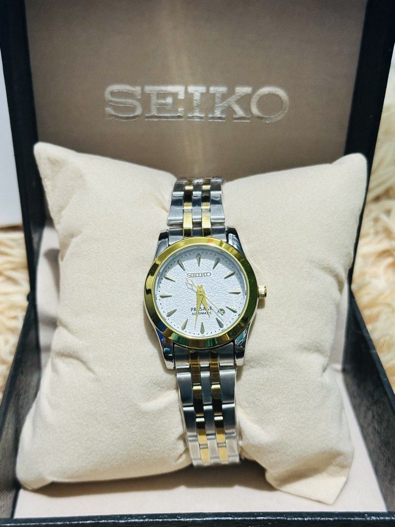 Seiko Presage Automatic Two-Tone Watch with Box (Category: Women's Watches) located in Manila. Submitted by mbcollections251 (Listing ID 1471237898, Image 1). Description: Seiko Presage automatic watch. Two-tone steel and gold bracelet, matching round bezel. Textured white dial, gold hands, date window at three o'clock. Clear glass case back showing the movement. Includes original Seiko presentation box with pillow. Clean piece, kept very well. G
