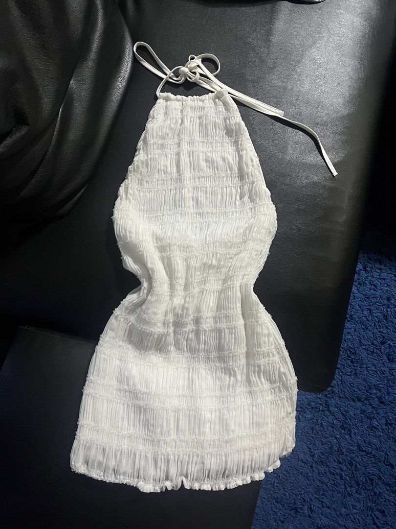 SHEIN White Smocked Halter Mini Dress (Category: Dresses) located in Plaridel. Submitted by vastwhale_38f456 (Listing ID 1471218346, Image 1). Description: - Brand: SHEIN - Condition: used once - Size: Medium / EUR 38 / US 6 - Style: Halter neck mini dress with adjustable tie straps - Fit: Fully smocked and stretchy body - Fabric: Lightweight pleated texture (95% polyester, 5% elastane).