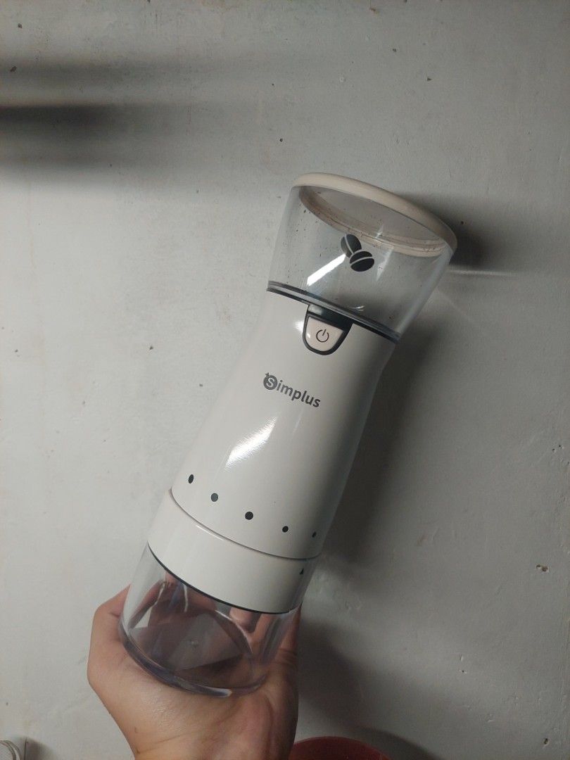 Simplus Electric Coffee Grinder (Category: Coffee Machines & Makers) located in Caloocan City. Submitted by elcloset.ph (Listing ID 1471283468, Image 1). Description: - Brand: Simplus - Color: White with clear acrylic body - Design: Compact, ergonomic, and easy to hold - Visibility: Clear chamber to easily monitor coffee grounds - Operation: Convenient front power button with a coffee bean icon - Benefit: Enjoy freshly ground coffee every single 