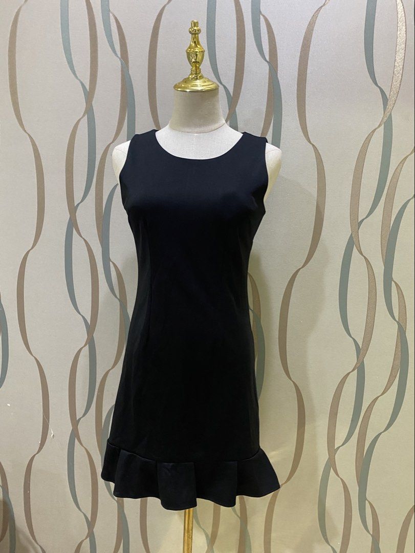 Small Black sleeveless mini dress with ruffle hem (Category: Dresses) located in Marikina City. Submitted by lovegoeson (Listing ID 1471125515, Image 2). Description: - Color: Solid black - Style: Sleeveless mini dress with scoop neckline - Fit: Fitted silhouette with clean, structured front seaming - Detail: Flared ruffle hem for added movement - Versatility: Great basic for casual outings or dressing up for dinner.