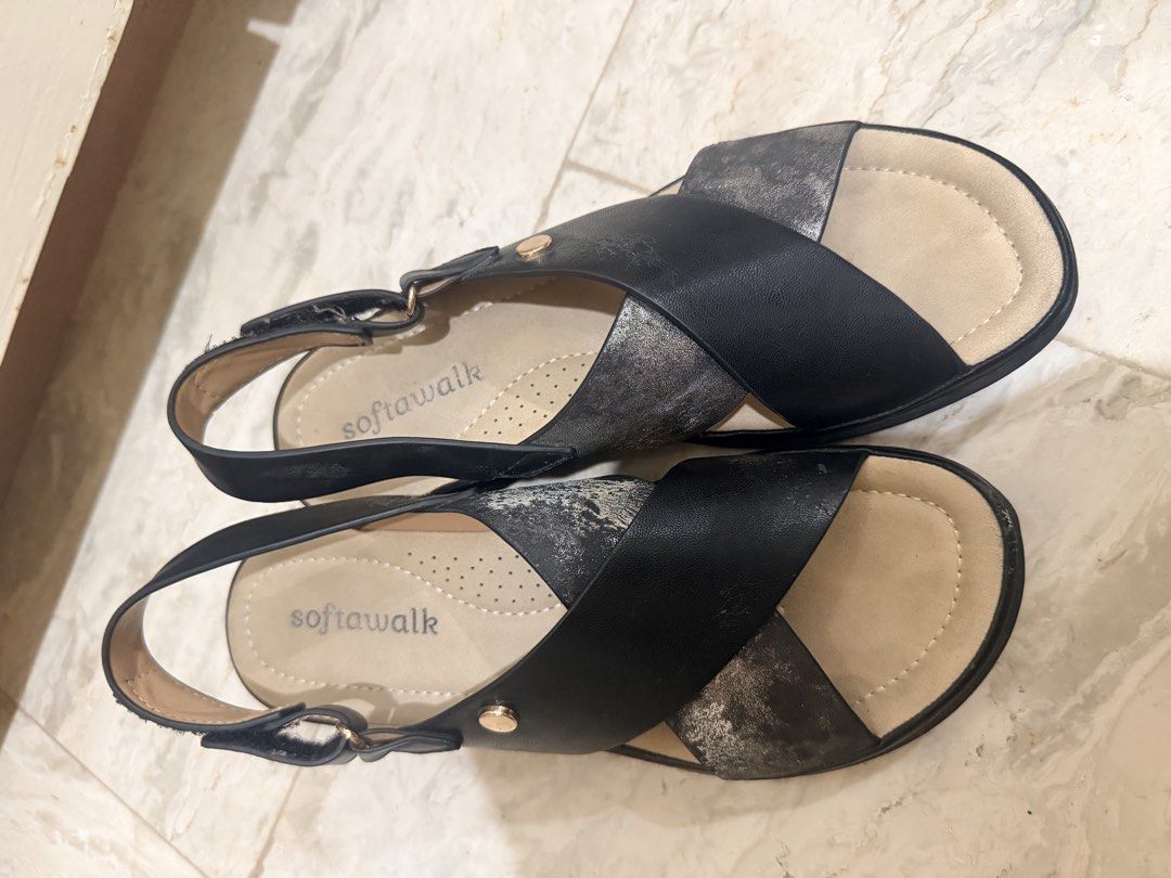 Softwalk Black and Silver Wedge Sandals (Category: Flats & Sandals) located in Batac City. Submitted by chocofromage (Listing ID 1471169728, Image 2). Description: - Brand: Softwalk - Style: Wedge sandals - Color: Black and metallic silver with gold-tone hardware - Comfort: Extra cushioned insoles, perfect for walking - Closure: Adjustable velcro back strap - Condition: Worn a few times, minimal wear on soles Size 6.