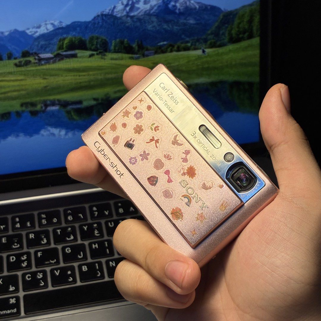 Sony Cyber-shot DSC-T20 Pink Digital Camera (Category: Cameras) located in Manila. Submitted by cedricksimbol7 (Listing ID 1471281398, Image 3). Description: Rare Sony Cyber-shot DSC-T20 (8.1 MP) Metallic Pink Tested and Working: - Smooth sliding cover for the lens - Working built-in flash and Super SteadyShot - English - Nostalgic Video & Audio (DM for Sample) Cosmetics: - Rare pastel metallic pink body with cute sticker accents (can be removed 