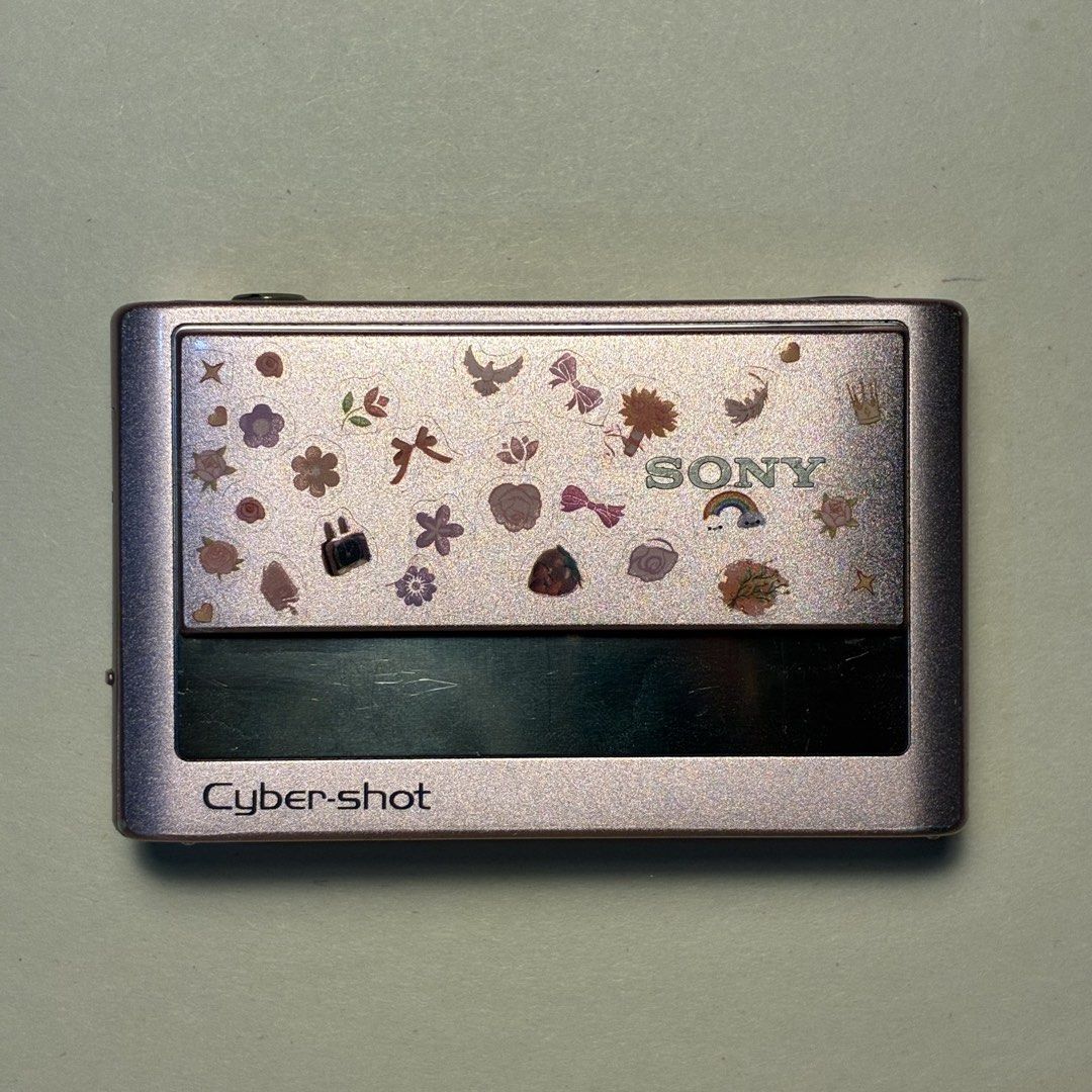 Sony Cyber-shot DSC-T20 Pink Digital Camera (Category: Cameras) located in Manila. Submitted by cedricksimbol7 (Listing ID 1471281398, Image 1). Description: Rare Sony Cyber-shot DSC-T20 (8.1 MP) Metallic Pink Tested and Working: - Smooth sliding cover for the lens - Working built-in flash and Super SteadyShot - English - Nostalgic Video & Audio (DM for Sample) Cosmetics: - Rare pastel metallic pink body with cute sticker accents (can be removed 