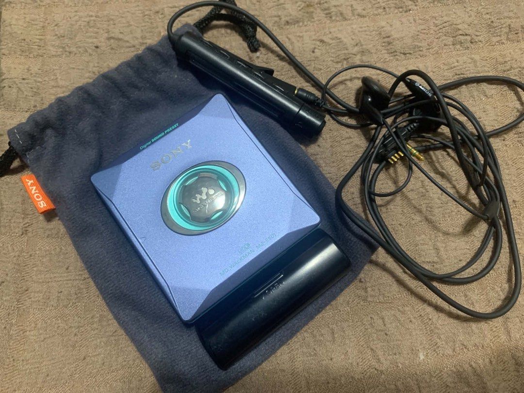 Sony MZ-E501 MiniDisc MD Walkman Purple Blue (Category: Portable Music Players) located in Manila. Submitted by thriftstoress (Listing ID 1471126791, Image 1). Description: - Model: Sony MZ-E501 Portable MiniDisc Player - Color: Stylish purple-blue shade - Inclusions: External battery case, original wired remote control earphones, and soft grey Sony drawstring pouch - Condition: Physical items complete; sold as-is / working condition - Ideal for: