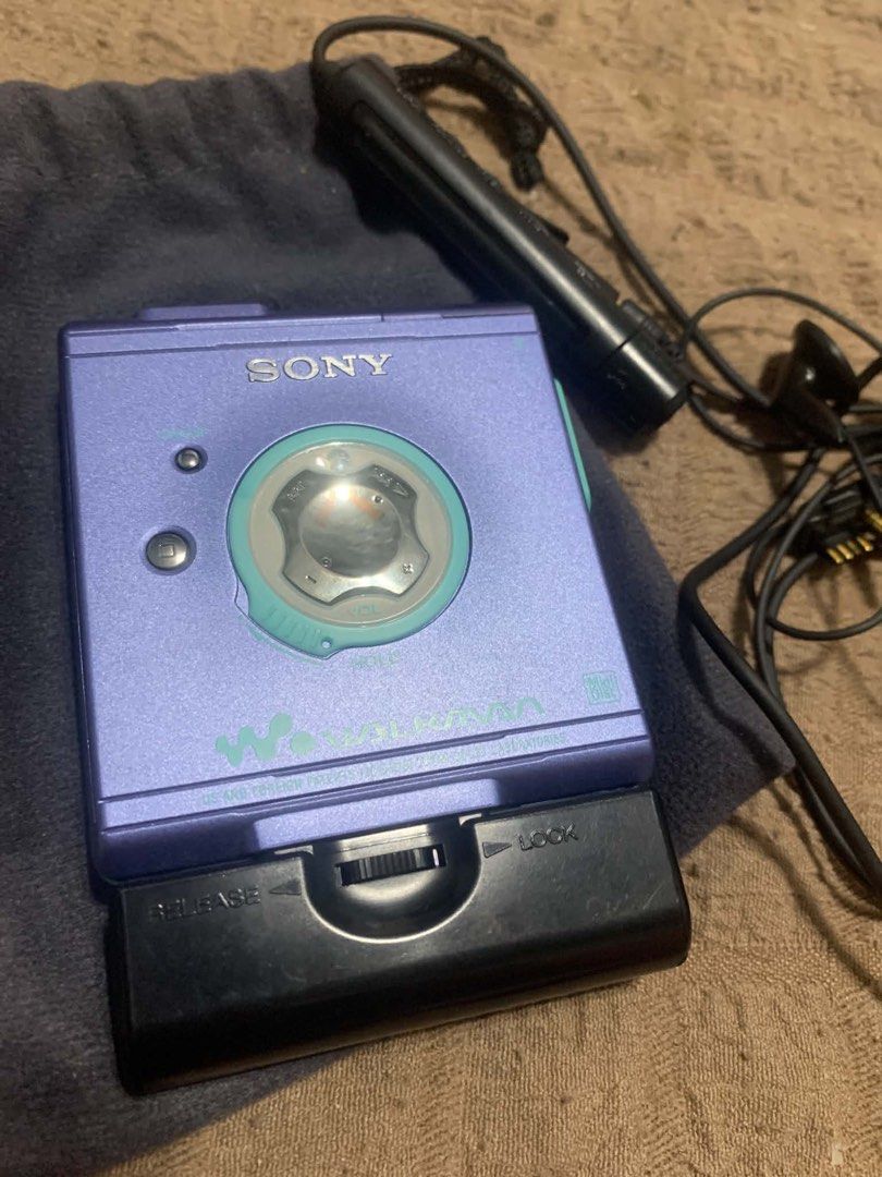 Sony MZ-E501 MiniDisc MD Walkman Purple Blue (Category: Portable Music Players) located in Manila. Submitted by thriftstoress (Listing ID 1471126791, Image 2). Description: - Model: Sony MZ-E501 Portable MiniDisc Player - Color: Stylish purple-blue shade - Inclusions: External battery case, original wired remote control earphones, and soft grey Sony drawstring pouch - Condition: Physical items complete; sold as-is / working condition - Ideal for: