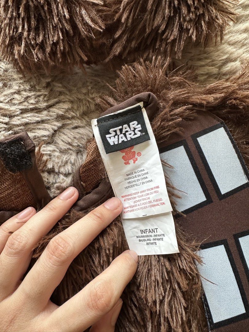 Star Wars Chewbacca Infant Costume (Category: Babies & Kids Fashion) located in Mandaluyong City. Submitted by kacbriz (Listing ID 1471171035, Image 3). Description: Star Wars Chewbacca costume for infants, size 6 to 12 months. Includes fuzzy brown jumpsuit, attached sash, bag detail, and separate headpiece with fluffy fur. Original packaging bag included. Soft material, warm style for babies. Halloween costume.