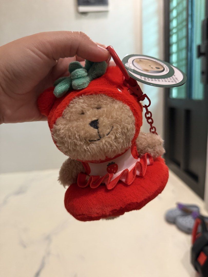 Starbucks Bearista Strawberry Plush Keychain (Category: Plushies & Soft Toys) located in Valenzuela. Submitted by sel000 (Listing ID 1471238225, Image 1). Description: - Authentic Starbucks Bearista Keychain - Adorable strawberry costume design with red dress and green leaf hood - Includes red plastic clasp and chain for easy attachment - Brand new with tag still hanging from the key ring - Perfect gift or addition to your Starbucks collection.