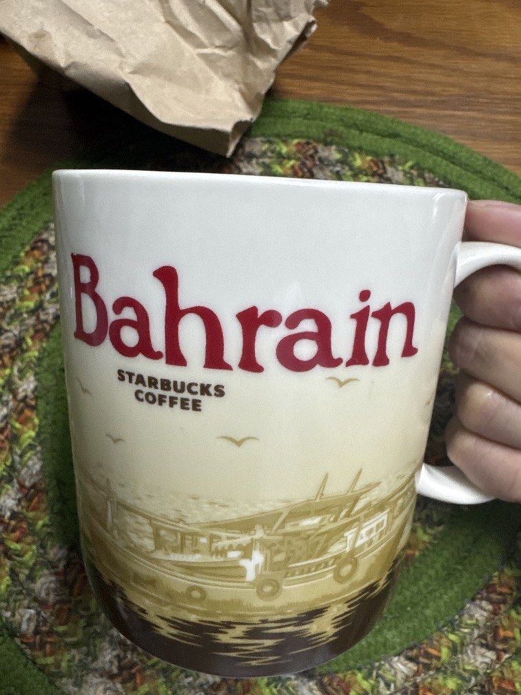 Starbucks Coffee Bahrain City Ceramic Mug (Category: Coffee & Tea Tableware) located in Las Pinas. Submitted by nekomeow22 (Listing ID 1471209724, Image 1). Description: - Authentic Starbucks City Mug from Bahrain - Large white ceramic design with bold red "Bahrain" text and classic Starbucks logo - Features unique brown nautical boat graphics wrapping the lower half - Contrast dark brown interior finish - Heavy-duty build with a comfortable, stu