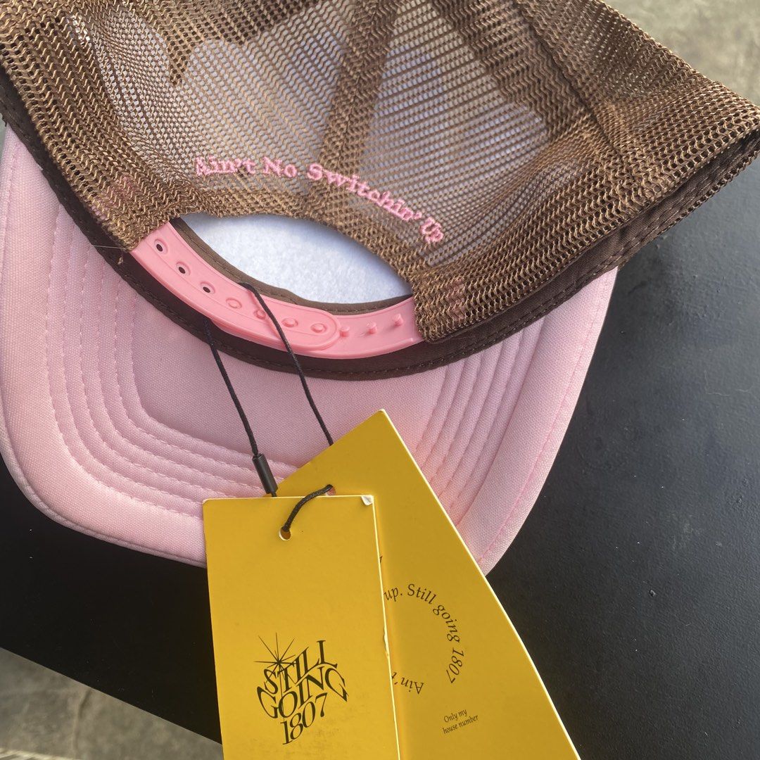 Still Going 1807 Trucker Hat Pink Brown (Category: Caps & Hats) located in Quezon City. Submitted by capsanywhere (Listing ID 1471193496, Image 2). Description: - Brand: Still Going 1807 trucker hat - Condition: Brand new with original yellow hang tags attached - Colors: Pink brim, white front panel, and brown mesh back - Front Design: Ice cream graphic with 'Still Going' script lettering - Back Detail: Embroidered phrase 'Ain't No Switchin' Up' 