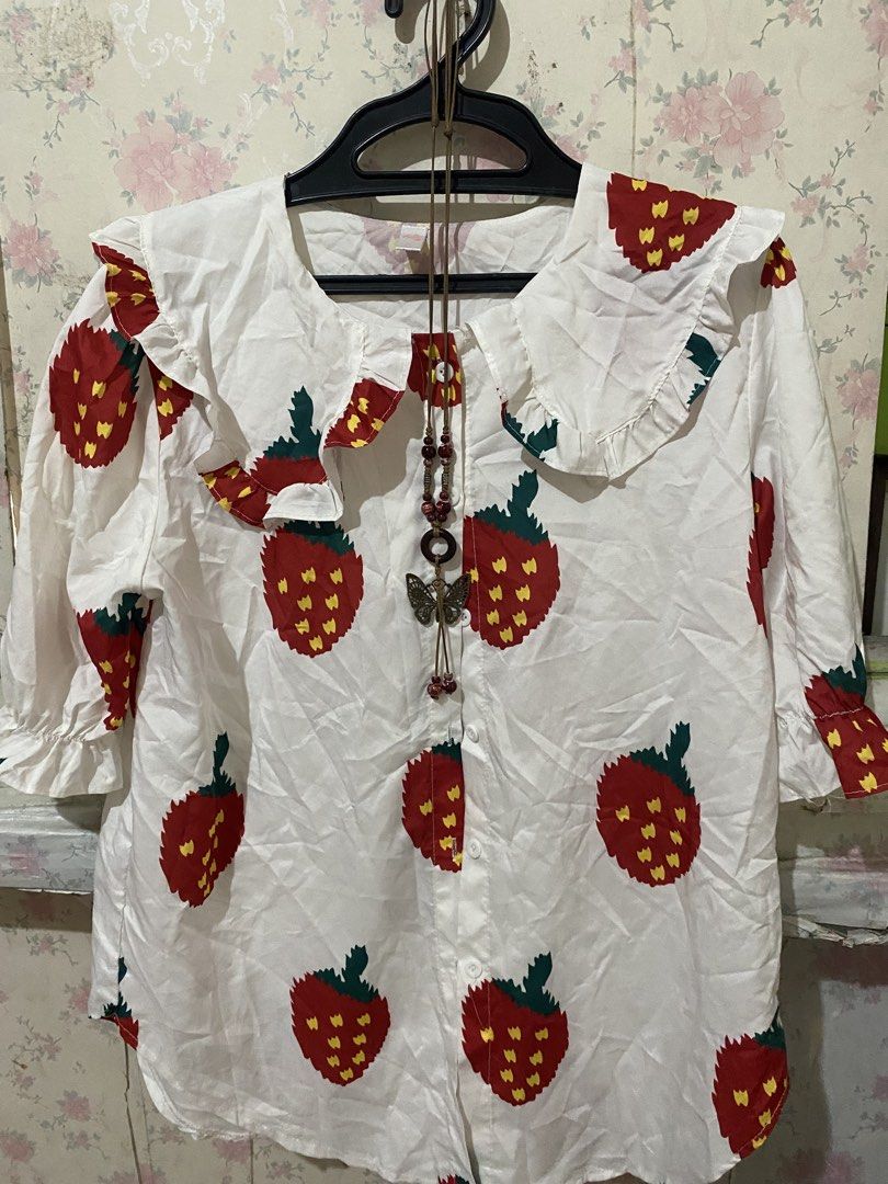 Strawberry Print Ruffle Collar Long Sleeve Blouse (Category: Blouses) located in Makati City. Submitted by oncejjang (Listing ID 1471125575, Image 1). Description: - Design: White button-down blouse featuring an adorable red strawberry print with green leaves and yellow seeds - Collar: Statement big ruffled sailor collar for a cute vintage aesthetic - Sleeves: Long sleeves finished with comfortable ruffled elastic cuffs - Fabric: Lightweight, bre