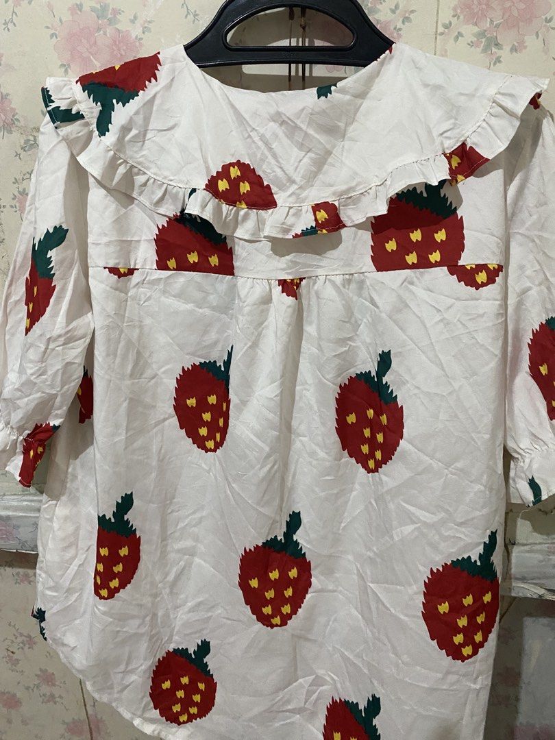 Strawberry Print Ruffle Collar Long Sleeve Blouse (Category: Blouses) located in Makati City. Submitted by oncejjang (Listing ID 1471125575, Image 3). Description: - Design: White button-down blouse featuring an adorable red strawberry print with green leaves and yellow seeds - Collar: Statement big ruffled sailor collar for a cute vintage aesthetic - Sleeves: Long sleeves finished with comfortable ruffled elastic cuffs - Fabric: Lightweight, bre
