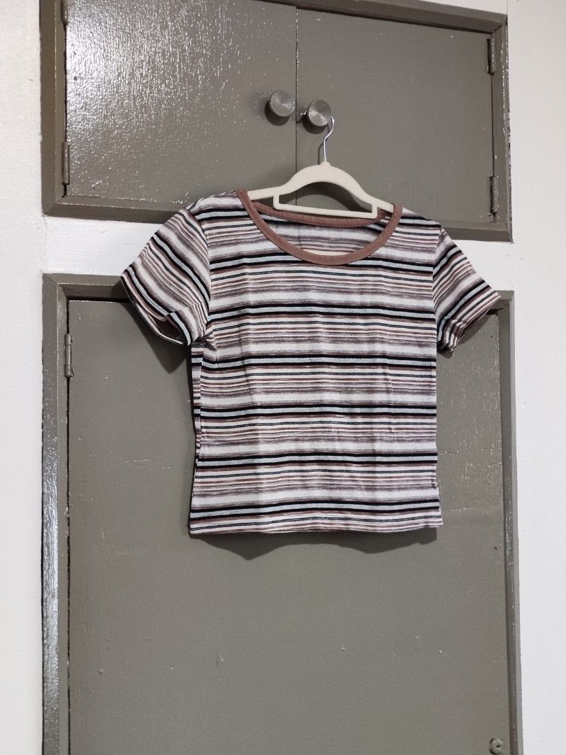 Striped Ringer Crop Top Brown White Black (Category: Shirts) located in Quezon City. Submitted by thestargazerspica (Listing ID 1471150435, Image 1). Description: - Color: Brown, white, and black stripes - Style: Ringer crop top with short sleeves - Details: Contrast brown collar trim, horizontal stripe pattern - Material: Lightweight and comfortable fabric - Fit: Easy to pair with high-waisted jeans or skirts - Condition: Clean inside and out, r
