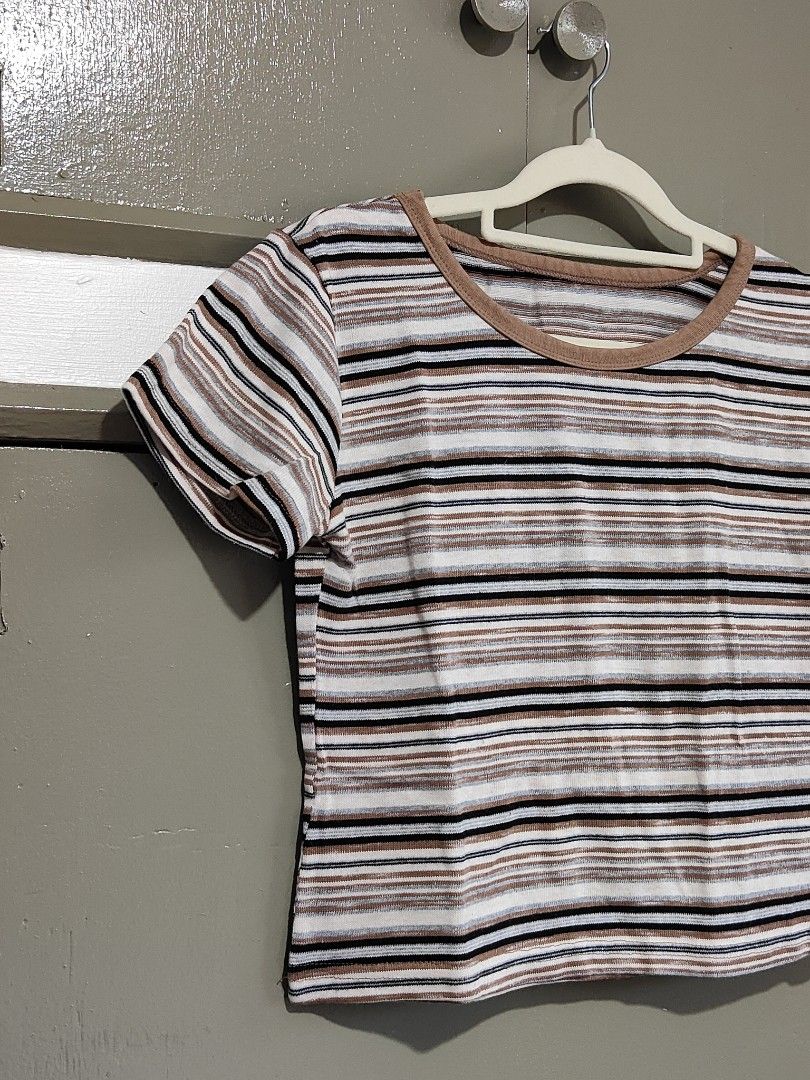 Striped Ringer Crop Top Brown White Black (Category: Shirts) located in Quezon City. Submitted by thestargazerspica (Listing ID 1471150435, Image 2). Description: - Color: Brown, white, and black stripes - Style: Ringer crop top with short sleeves - Details: Contrast brown collar trim, horizontal stripe pattern - Material: Lightweight and comfortable fabric - Fit: Easy to pair with high-waisted jeans or skirts - Condition: Clean inside and out, r