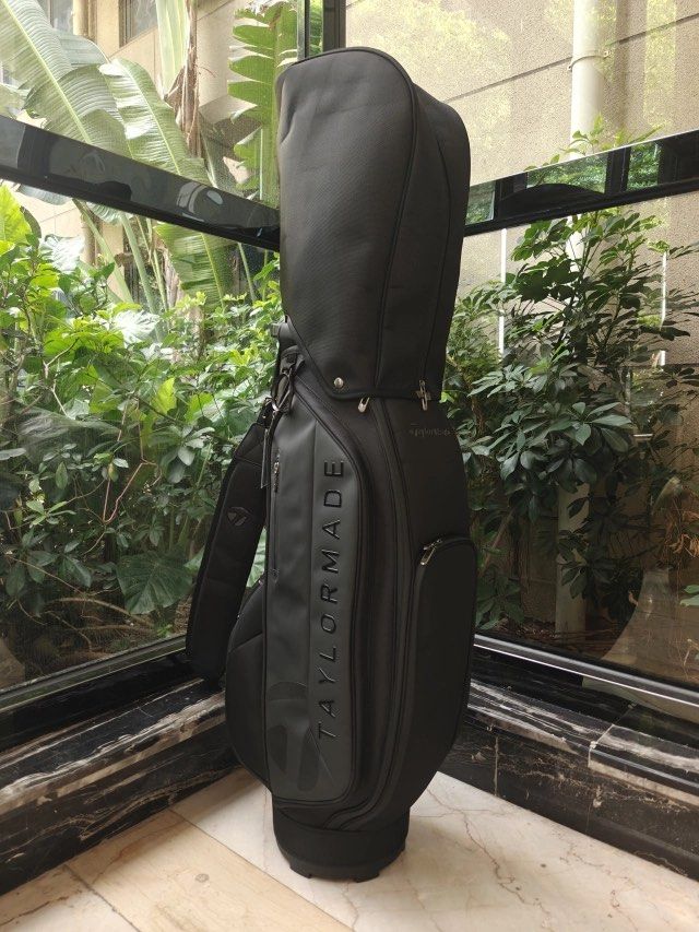 TaylorMade Black Cart Golf Bag (Category: Golf) located in Taytay. Submitted by kylalm (Listing ID 1471223105, Image 3). Description: - Brand: TaylorMade - Color: Solid black with big embossed logo - Condition: Brand new with tags still attached - Storage: Multiple zippered pockets for balls, tees, and gear - Comfort & Protection: Includes padded shoulder strap and matching rain hood cover - Convenience: Sturdy base designed to fit standard cart 