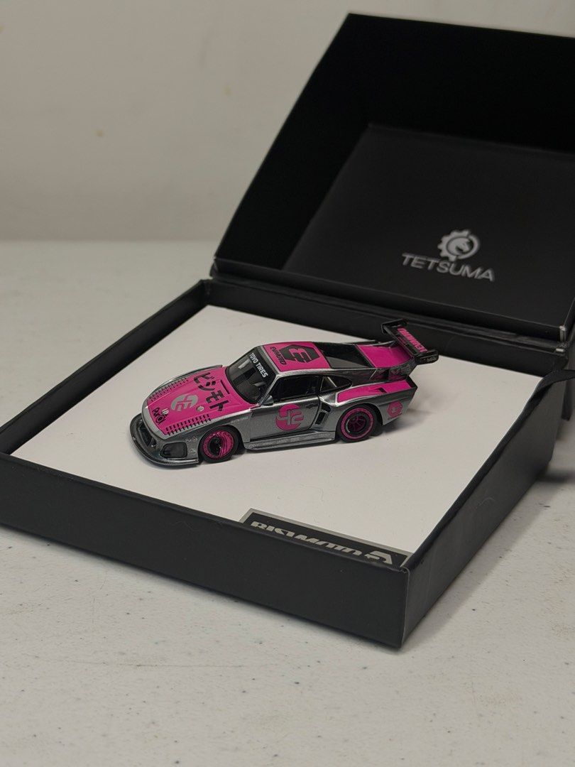 Tetsuma Bisimoto 1:64 Diecast (Category: Vehicle & Diecast Models) located in Manila. Submitted by kelvs1435 (Listing ID 1471187780, Image 1). Description: Tetsuma Bisimoto Make: Bisimoto Model: 935 K3 (EVMOTO) Scale: 1:64 Size: 7.5 cm long, 3.25 cm wide, 1.5 cm high Exterior Color: Metallic Grey with Pink Livery Interior Color: Black Seats, White Roll Cage, Purple Accents Cast Material: Resin and Hand-Made Production Run: Limited Edition 1000 Pi