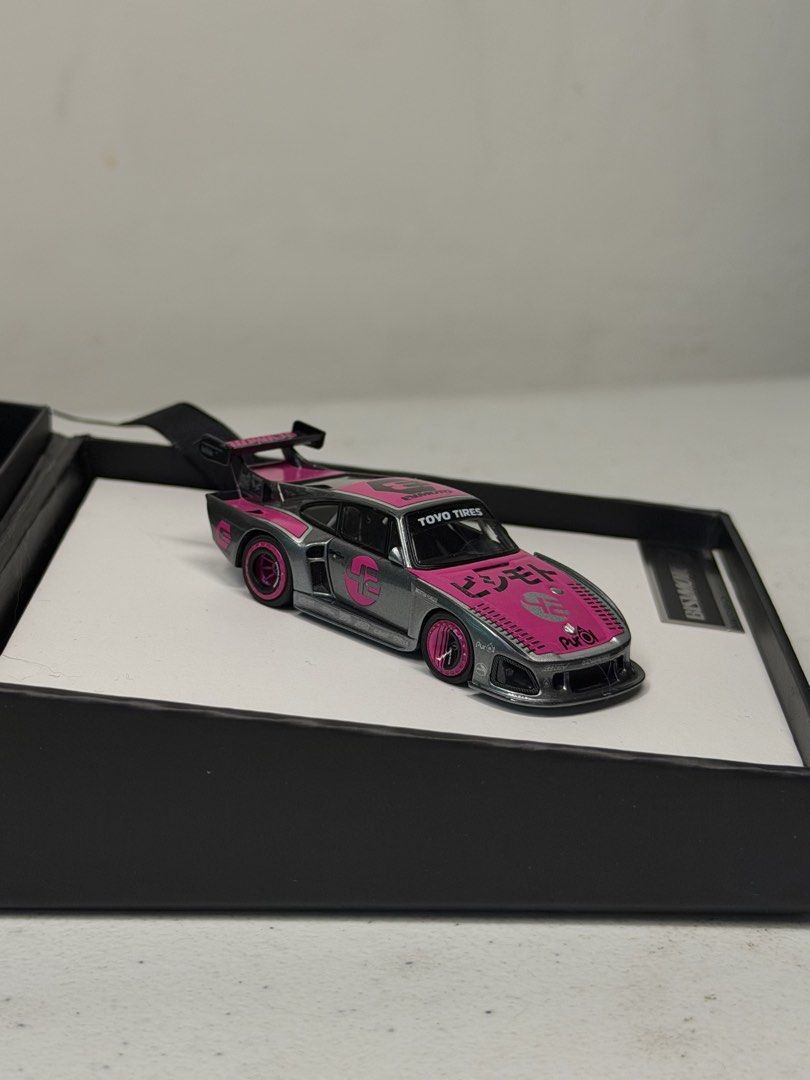 Tetsuma Bisimoto 1:64 Diecast (Category: Vehicle & Diecast Models) located in Manila. Submitted by kelvs1435 (Listing ID 1471187780, Image 3). Description: Tetsuma Bisimoto Make: Bisimoto Model: 935 K3 (EVMOTO) Scale: 1:64 Size: 7.5 cm long, 3.25 cm wide, 1.5 cm high Exterior Color: Metallic Grey with Pink Livery Interior Color: Black Seats, White Roll Cage, Purple Accents Cast Material: Resin and Hand-Made Production Run: Limited Edition 1000 Pi