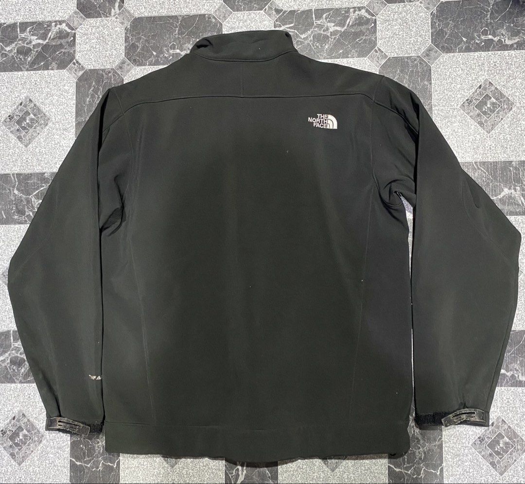 The North Face Black Jacket (Category: Coats, Jackets and Outerwear) located in Baguio. Submitted by flynes (Listing ID 1471264305, Image 2). Description: - Brand: The North Face - Style: Men's Softshell Jacket - Color: Black - Size: Men's Large Regular - Dimensions: L-27.5”, w-23.5”, sleeves-26” - Lining: Warm fleece interior - Features: Full zip closure, zippered chest pocket, two hand pockets, and adjustable velcro cuffs - Branding: Embroidere