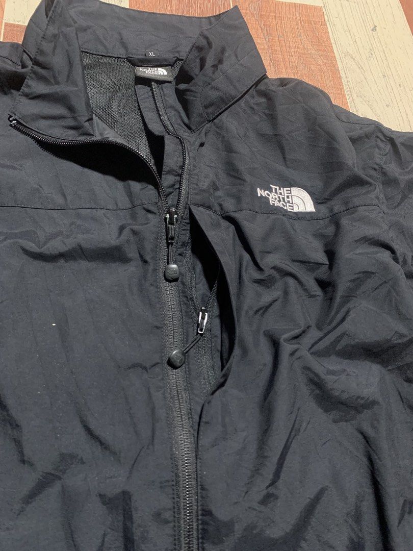 The North Face Black Windbreaker Jacket XL (Category: Coats, Jackets and Outerwear) located in Kidapawan. Submitted by thrift_gem (Listing ID 1471235521, Image 3). Description: - Brand: The North Face - Color: Classic Black with Contrast White Logos (Chest & Back) - Size: XL - Material: Lightweight with breathable mesh interior lining - Closure: Full zip front - Pockets: Two secure zippered hand pockets - Adjustability: Drawcord at hem and collar