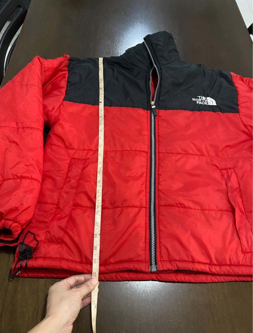 The North Face Red Black Puffer Jacket (Category: Coats, Jackets and Outerwear) located in Calamba. Submitted by mizkei (Listing ID 1471256397, Image 3). Description: ISSUE SEEN LAST SLIDES - Brand: The North Face - Color: Red and black color block - Closure: Full front zip with high collar - Warmth: Quilted padding throughout - Features: Front pockets, Velcro cuffs, and adjustable toggle hem .