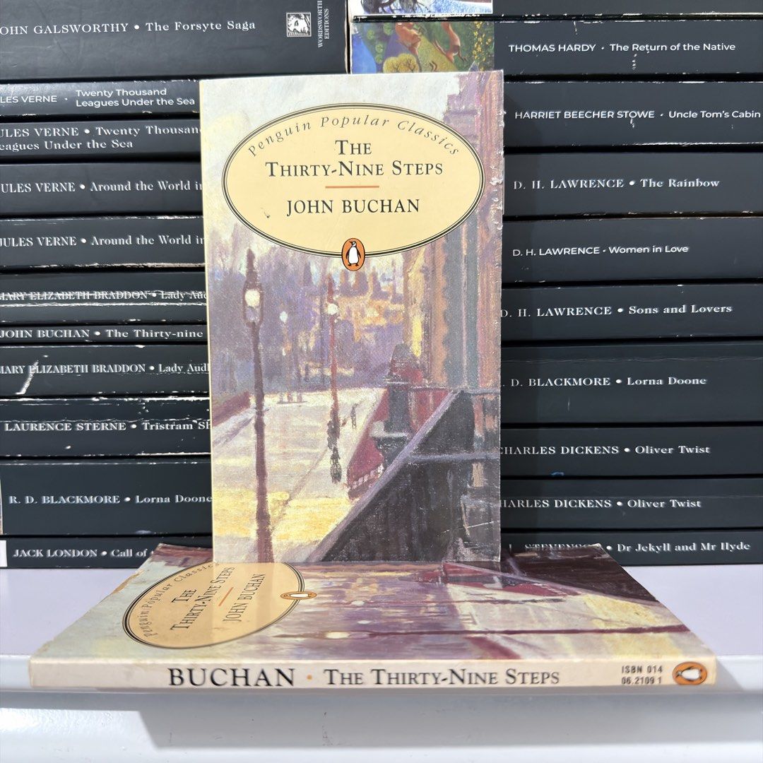 The Thirty-Nine Steps by John Buchan Penguin Popular Classics (Category: Storybooks) located in Lingayen. Submitted by readwjane (Listing ID 1471135878, Image 1). Description: - Title: John Buchan Thriller Novel (Penguin Popular Classics) - Genre: Classic spy story and cross-country chase adventure - Format: Paperback with vintage street scene cover art - Condition: Clean pages and solid spine - Ideal for: Fans of classic adventure fiction.
