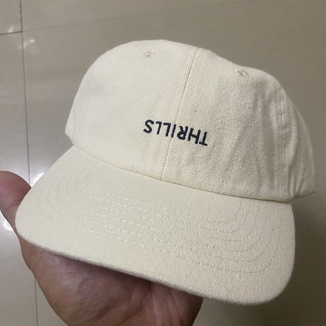 Thrills Off White Embroidered Logo Baseball Cap (Category: Caps & Hats) located in Quezon City. Submitted by capsanywhere (Listing ID 1471197136, Image 1). Description: - Brand: Thrills - Color: Off-white - Material: Canvas - Design: Embroidered branding on front panel - Closure: Adjustable strapback with bronze-tone metal buckle (features stamped palm tree logo) - Condition: Brand new with internal tags and original swing tag attached.