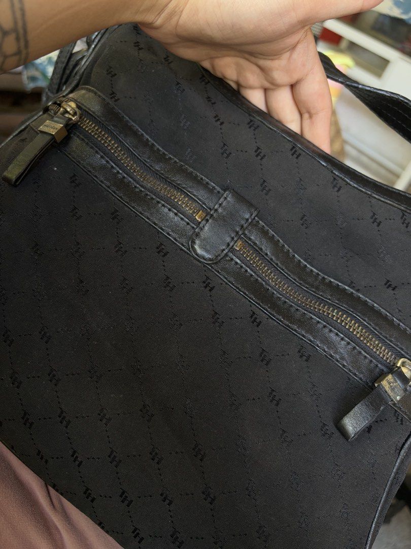 Tommy Hilfiger Monogram Black hobo Bag (Category: Shoulder Bags) located in Manila. Submitted by dorilorenr48954 (Listing ID 1471226747, Image 3). Description: - Brand: Tommy Hilfiger - Color: Classic Black with Monogram Pattern - Material: Monogram fabric with premium leather strap and trim details - Compartments: Front zipper pocket and spacious main compartment with top zip closure - Interior: Fabric-lined with an authentic stamped leather log