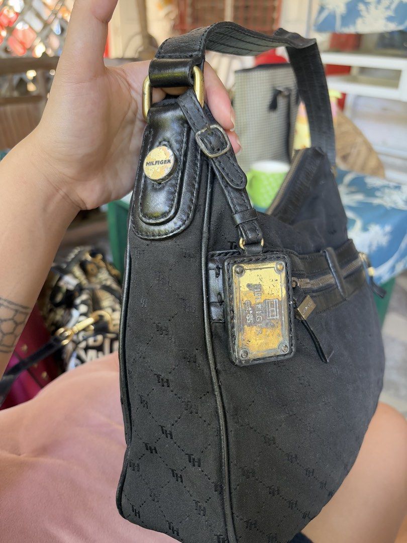 Tommy Hilfiger Monogram Black hobo Bag (Category: Shoulder Bags) located in Manila. Submitted by dorilorenr48954 (Listing ID 1471226747, Image 2). Description: - Brand: Tommy Hilfiger - Color: Classic Black with Monogram Pattern - Material: Monogram fabric with premium leather strap and trim details - Compartments: Front zipper pocket and spacious main compartment with top zip closure - Interior: Fabric-lined with an authentic stamped leather log