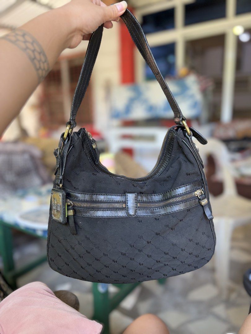 Tommy Hilfiger Monogram Black hobo Bag (Category: Shoulder Bags) located in Manila. Submitted by dorilorenr48954 (Listing ID 1471226747, Image 1). Description: - Brand: Tommy Hilfiger - Color: Classic Black with Monogram Pattern - Material: Monogram fabric with premium leather strap and trim details - Compartments: Front zipper pocket and spacious main compartment with top zip closure - Interior: Fabric-lined with an authentic stamped leather log