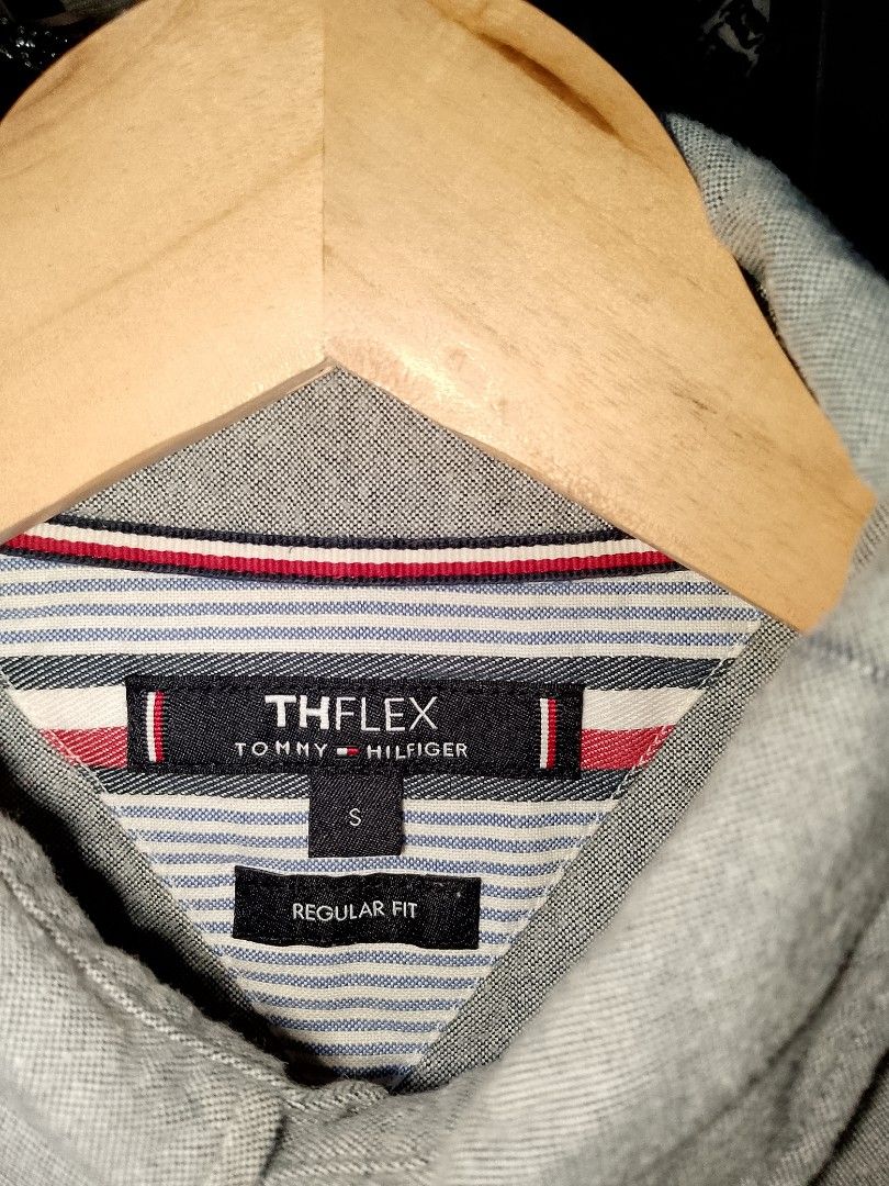 Tommy Hilfiger TH Flex Grey Button-Down Shirt Size S (Category: Tshirts & Polo Shirts ) located in Manila. Submitted by mjthrifted_second (Listing ID 1471196556, Image 2). Description: - Brand: Tommy Hilfiger (TH Flex Collection) - Color: Grey - Size: S (170/100B) / Regular Fit -Dimes: 20/27 - Material: 97% Cotton, 3% Elastane (Slight stretch for comfort) - Details: Classic button-down collar with embroidered flag logo on chest - Condition: Clean