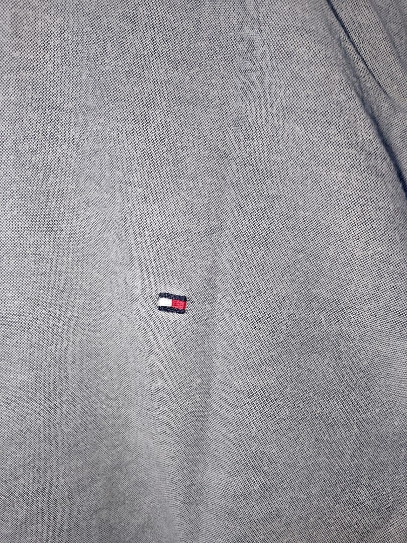 Tommy Hilfiger TH Flex Grey Button-Down Shirt Size S (Category: Tshirts & Polo Shirts ) located in Manila. Submitted by mjthrifted_second (Listing ID 1471196556, Image 3). Description: - Brand: Tommy Hilfiger (TH Flex Collection) - Color: Grey - Size: S (170/100B) / Regular Fit -Dimes: 20/27 - Material: 97% Cotton, 3% Elastane (Slight stretch for comfort) - Details: Classic button-down collar with embroidered flag logo on chest - Condition: Clean