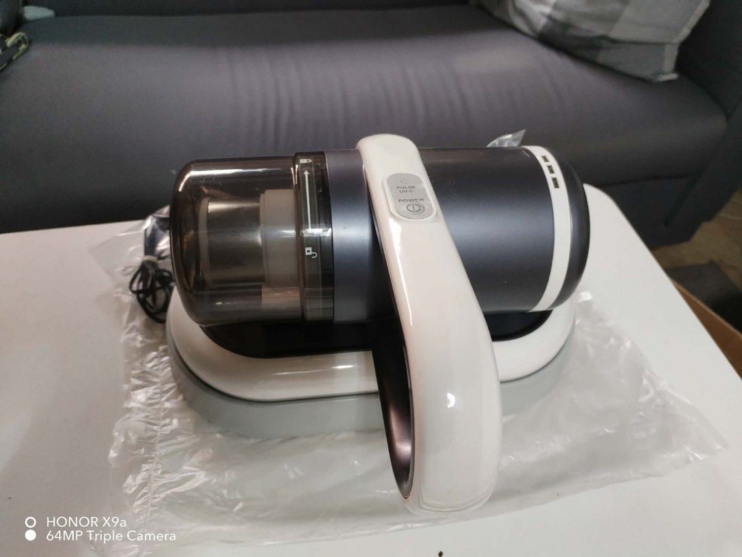 UV Care Cordless Vacuum Cleaner with Charging Dock (Category: Vacuum Cleaner & Housekeeping) located in Pasig City. Submitted by jacq0301 (Listing ID 1471132630, Image 3). Description: - Brand: UV Care - Type: Cordless handheld vacuum cleaner - Color: Dark grey and white - Condition: Clean and ready to use - Features: Power button and pulse UV-C button on top handle, easy-empty dust cup - Inclusions: Charging dock base, power adapter in original 