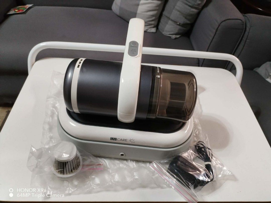UV Care Cordless Vacuum Cleaner with Charging Dock (Category: Vacuum Cleaner & Housekeeping) located in Pasig City. Submitted by jacq0301 (Listing ID 1471132630, Image 2). Description: - Brand: UV Care - Type: Cordless handheld vacuum cleaner - Color: Dark grey and white - Condition: Clean and ready to use - Features: Power button and pulse UV-C button on top handle, easy-empty dust cup - Inclusions: Charging dock base, power adapter in original 