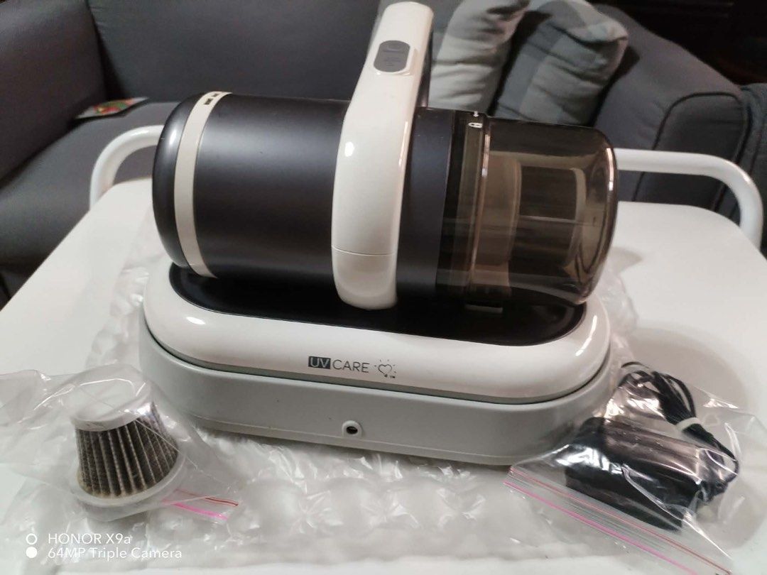 UV Care Cordless Vacuum Cleaner with Charging Dock (Category: Vacuum Cleaner & Housekeeping) located in Pasig City. Submitted by jacq0301 (Listing ID 1471132630, Image 1). Description: - Brand: UV Care - Type: Cordless handheld vacuum cleaner - Color: Dark grey and white - Condition: Clean and ready to use - Features: Power button and pulse UV-C button on top handle, easy-empty dust cup - Inclusions: Charging dock base, power adapter in original 