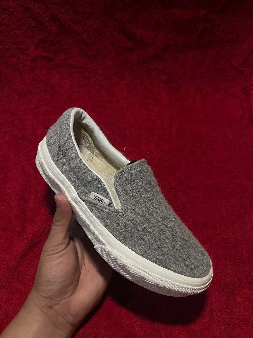 Vans Grey Textured Knit Slip-On Sneakers (Category: Sneakers) located in General Santos City (Dadiangas). Submitted by vashcollection16 (Listing ID 1471275461, Image 1). Description: - Brand: Vans - Style: Slip-on with textured grey knit upper - Soles: Classic waffle rubber outsole showing practically no wear - Details: White midsole trim, red 'Off The Wall' heel tab, and clean white interior lining - Condition: Excellent, barely worn - Feature: 