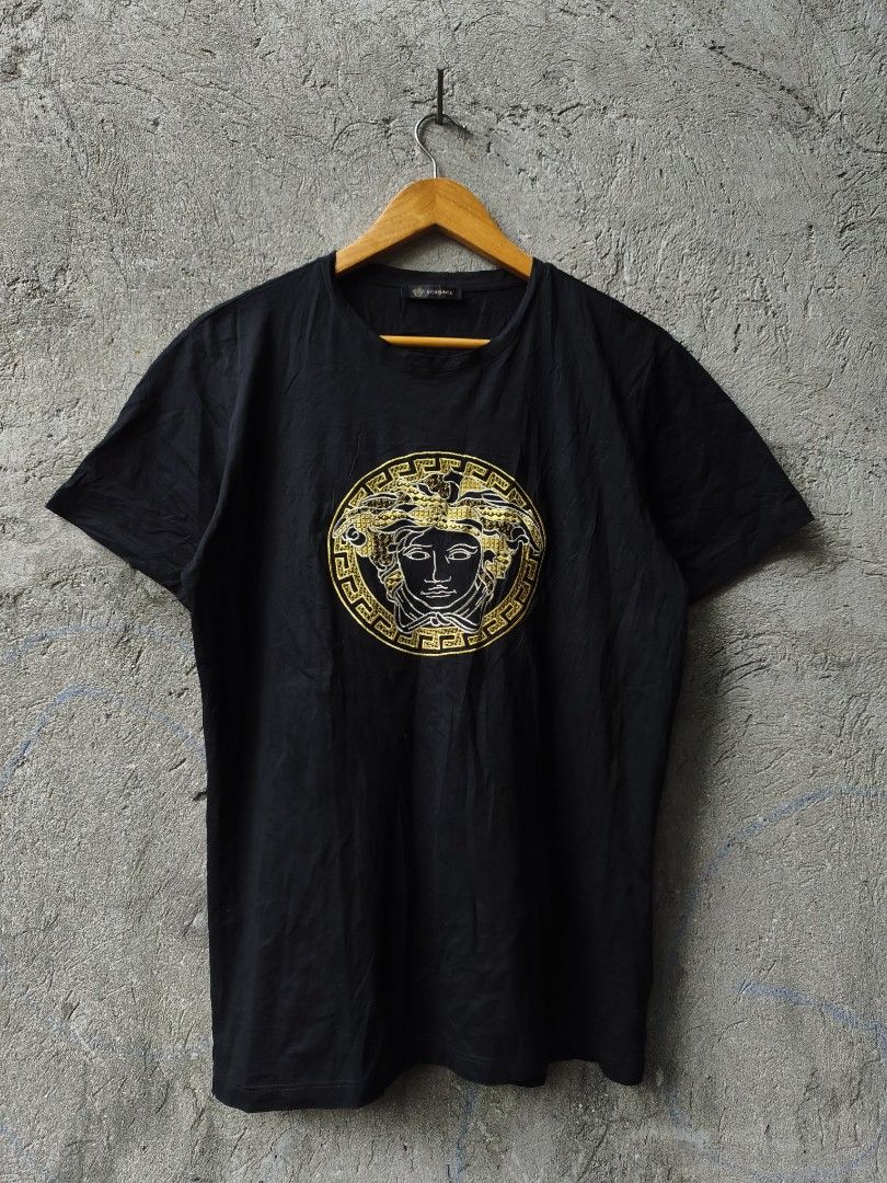 Versace Medusa Head Black T-Shirt (Category: Tshirts & Polo Shirts ) located in Taytay. Submitted by bunsoanglo096 (Listing ID 1471196622, Image 2). Description: - Brand: Versace - Color: Black - Material: 100% Cotton - Size: XL - Origin: Made in Italy - Design: Large gold and silver embroidered Medusa logo with stud embellishments on the chest - Details: Includes collar tag and authenticity label - Condition: Great overall condition with clean f