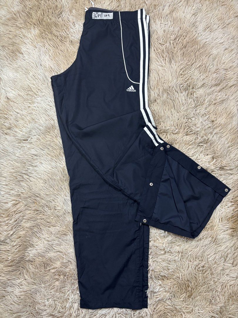Vintage Adidas Track Pants Snap Button Sides (Category: Joggers) located in Cavite. Submitted by sidirvinp76902 (Listing ID 1471207989, Image 2). Description: - Brand: Adidas - Color: Navy blue with classic white stripes - Features: Full snap buttons along the legs for easy styling, inner mesh lining - Fit: Elastic waistband (fits waist sizes 26 to 32) - Length: 40 inches.