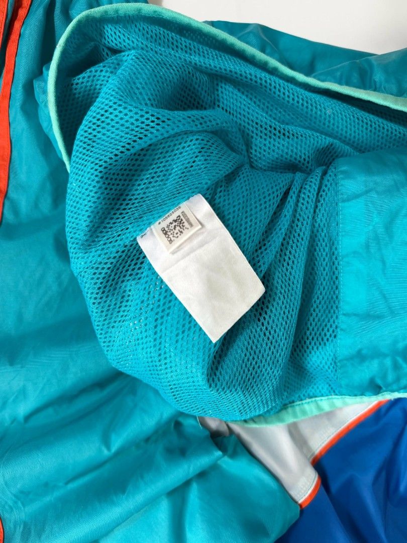 Vintage Adidas Windbreaker (Category: Coats, Jackets and Outerwear) located in Valenzuela. Submitted by veriez_gems (Listing ID 1471269128, Image 3). Description: Adidas Originals (featuring classic Trefoil logo branding) ​Colorway: Dynamic multi-color blocking featuring teal green, deep royal blue, crisp white chevron accents, and vivid orange 3-stripes ​Design & Fit Features: ​Full-zip front closure with a fitted hood for stylish coverage ​Clas