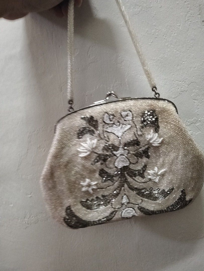 Vintage Beaded Handbag with Floral Pattern (Category: Shoulder Bags) located in Gasan. Submitted by AngeliqueKaye (Listing ID 1471210481, Image 2). Description: - Stunning vintage-style evening bag with intricate floral embroidery - Metallic silver and white beads on a chic light champagne base - Secure metal kiss-lock top closure - Features a convenient single beaded top handle - Compact size: comfortably fits your phone, lipstick, and keys - Pe