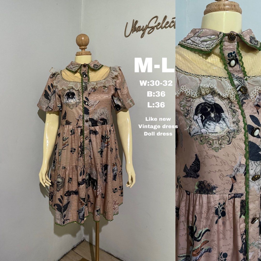 Vintage Doll Dress (Category: Dresses) located in Polomolok. Submitted by ezcollection (Listing ID 1471134105, Image 1). Description: - Style: Pink vintage-style tiered dress with eclectic newspaper, knight, and floral print - Details: Short puff sleeves, delicate lace collar trim, front button closure, and contrasting green piping - Size: Fits Medium to Large - Measurements: Bust 36" | Waist 30-32" | Length 36" - Condition: Excellent pre-loved c