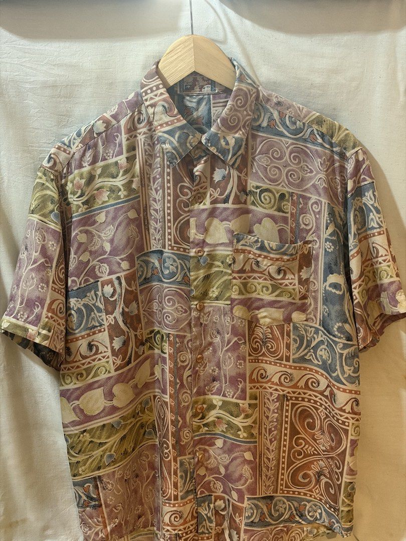 Vintage short sleeve button down shirt abstract pattern (Category: Tshirts & Polo Shirts ) located in Quezon City. Submitted by the_exit.png (Listing ID 1471184964, Image 1). Description: - Style: Short sleeve button-down shirt with intricate vintage patterns - Colors: Multicolored design featuring purples, blues, greens, and browns - Features: Standard collar, single left chest pocket, and front button closure - Material: Lightweight fabric, ide