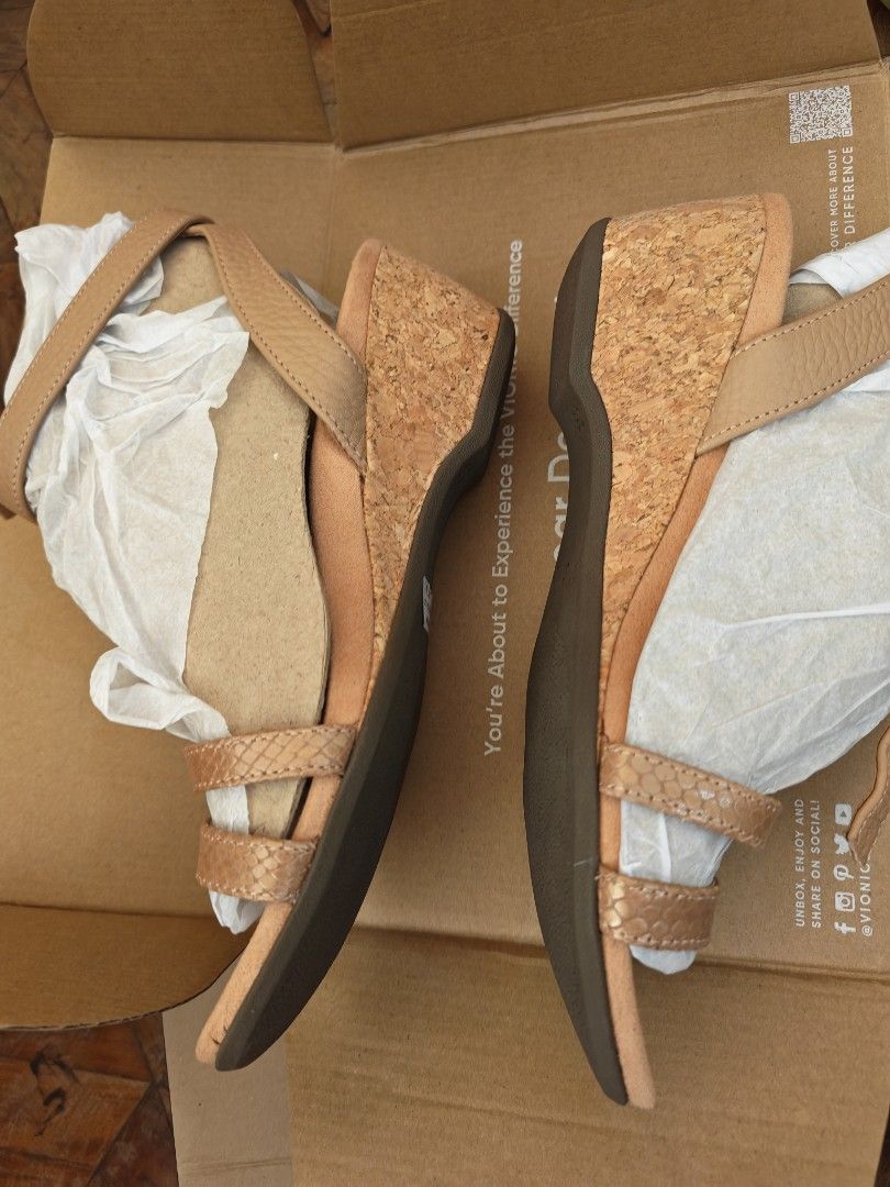 Vionic Orlanda Cork Wedge Sandals Tan Size (Category: Wedges) located in Manila. Submitted by un.hoarding.momma (Listing ID 1471229004, Image 2). Description: - Brand: Vionic - Style: Orlanda Wedge Sandals - Color: Tan - Heel: Cork wedge with durable brown rubber sole - Closure: Strappy design with adjustable ankle buckle - Condition: Brand new with original price tag attached - Packaging: Includes original Vionic shoebox and wrapping paper.