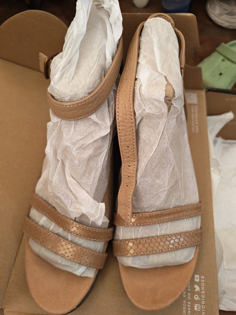Vionic Orlanda Cork Wedge Sandals Tan Size (Category: Wedges) located in Manila. Submitted by un.hoarding.momma (Listing ID 1471229004, Image 1). Description: - Brand: Vionic - Style: Orlanda Wedge Sandals - Color: Tan - Heel: Cork wedge with durable brown rubber sole - Closure: Strappy design with adjustable ankle buckle - Condition: Brand new with original price tag attached - Packaging: Includes original Vionic shoebox and wrapping paper.