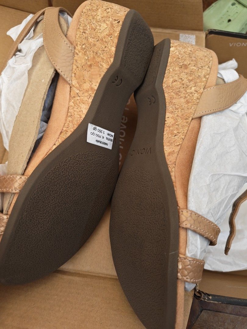 Vionic Orlanda Cork Wedge Sandals Tan Size (Category: Wedges) located in Manila. Submitted by un.hoarding.momma (Listing ID 1471229004, Image 3). Description: - Brand: Vionic - Style: Orlanda Wedge Sandals - Color: Tan - Heel: Cork wedge with durable brown rubber sole - Closure: Strappy design with adjustable ankle buckle - Condition: Brand new with original price tag attached - Packaging: Includes original Vionic shoebox and wrapping paper.