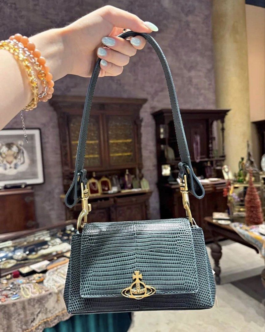 Vivienne Westwood Hazel Medium Handbag (Category: Shoulder Bags) located in Quezon City. Submitted by adelly23 (Listing ID 1471133111, Image 1). Description: Sis! Selling this gorgeous authentic Vivienne Westwood Hazel Medium Handbag in a stunning dark green lizard-embossed texture. It comes with chic antique brass hardware, including the iconic orb logo on the front flap, and a detachable strap so you can wear it your way. The interior features 