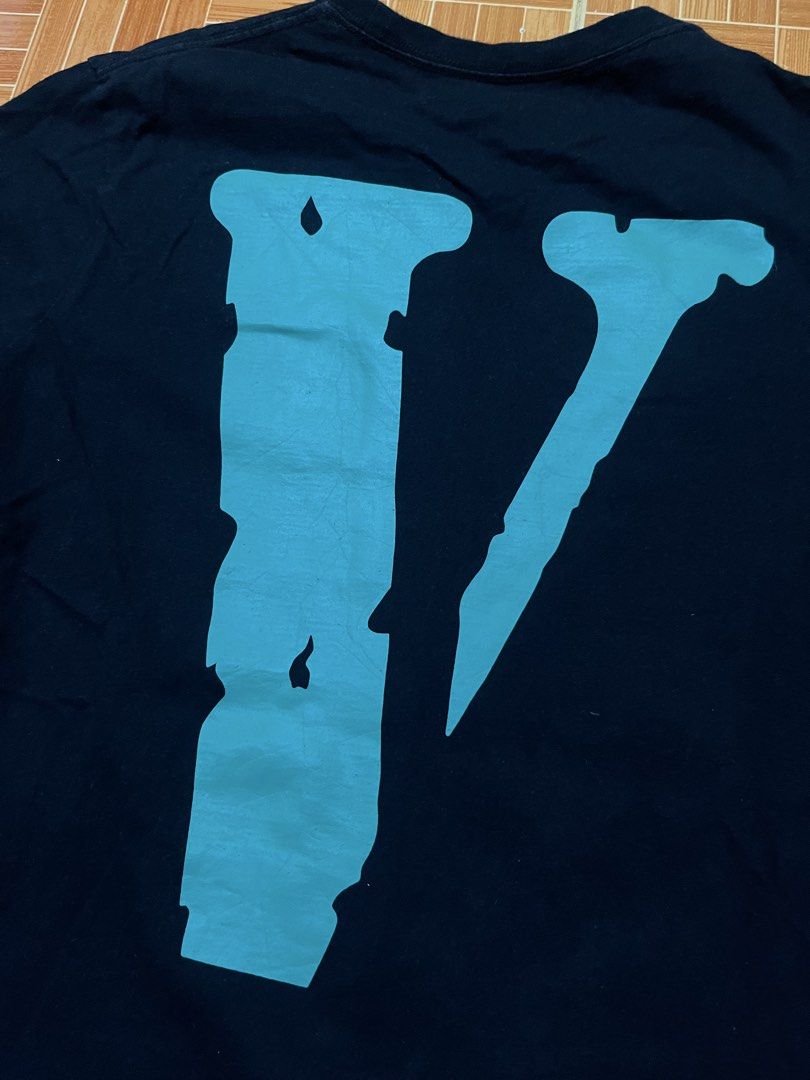 Vlone Blue Logo T-shirt (Category: Tshirts & Polo Shirts ) located in Manila. Submitted by jlfamiliar69452 (Listing ID 1471146809, Image 2). Description: - Brand: Vlone - Color: Dark Navy Blue with light blue lettering - Size: Medium (M) - Design: Classic front print and signature large V graphic on the back - Authenticity: Includes interior Vlone neck tag and wash tag with holographic security sticker - Material: Clean, comfortable cotton - Cond