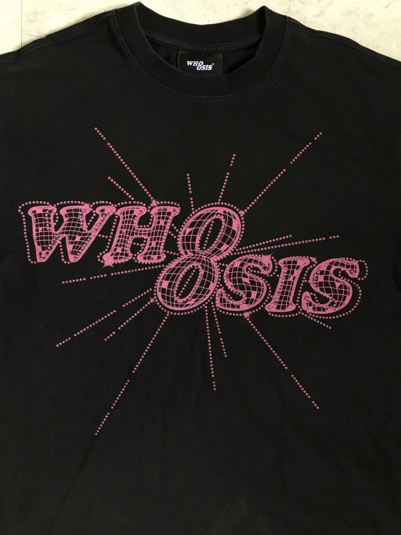 WH8SIS Black Graphic T-Shirt (Category: Tshirts & Polo Shirts ) located in Banga. Submitted by jorguarino (Listing ID 1471140876, Image 3). Description: - Brand: WH8SIS - Color: Black - Material: 100% Cotton - Design: Large pink sparkly graphic print with grid and starburst patterns - Neckline: Standard crew neck - Details: Includes neckline tag and interior care label - Origin: Made in China.